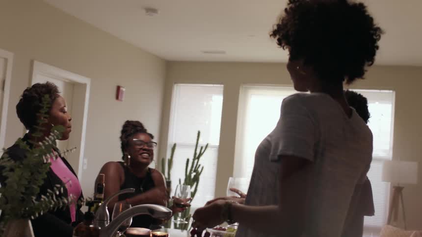 Women talk together, eat and smile