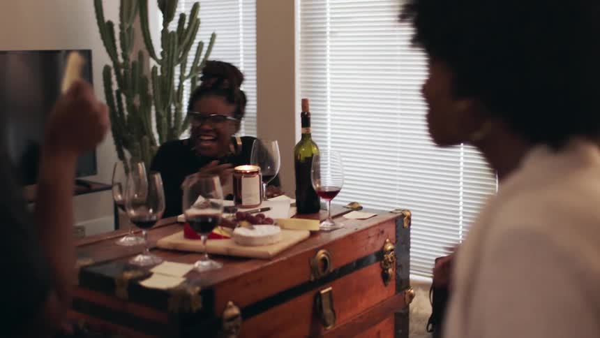 Women laugh having a party together