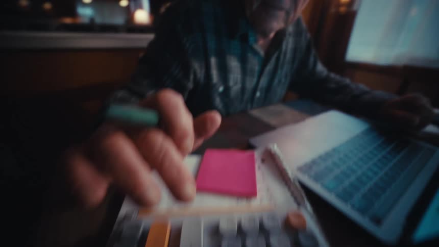 Elderly man typing on a calculator and becoming happy