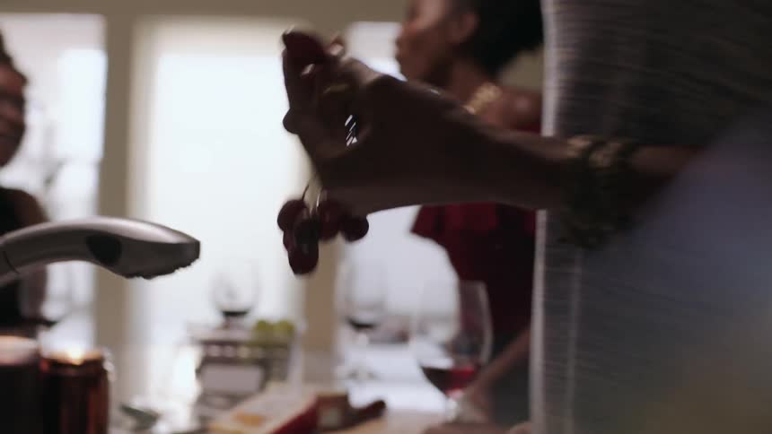 Women eat grapes, drink and talk