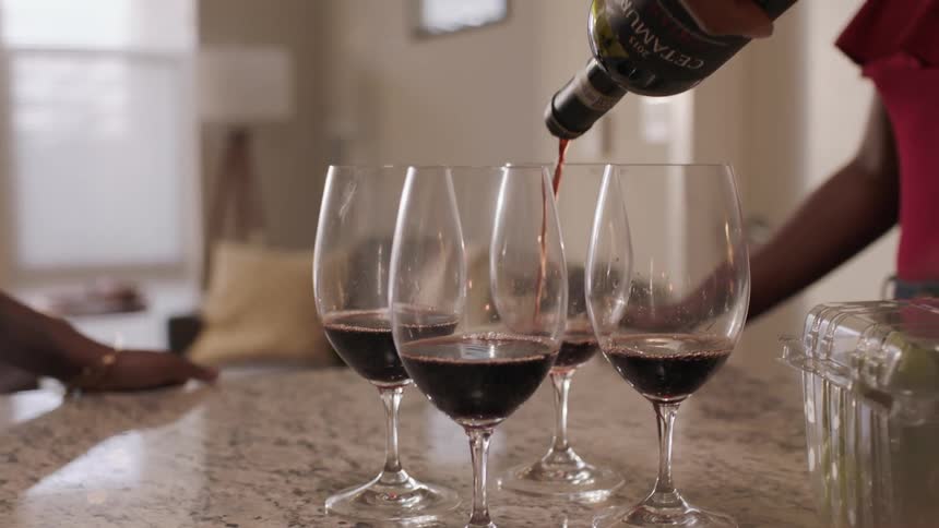 Four wine glasses are filled