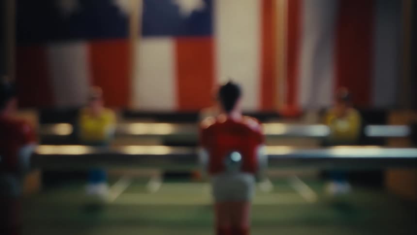 Foosball table positioned in a dimly lit room