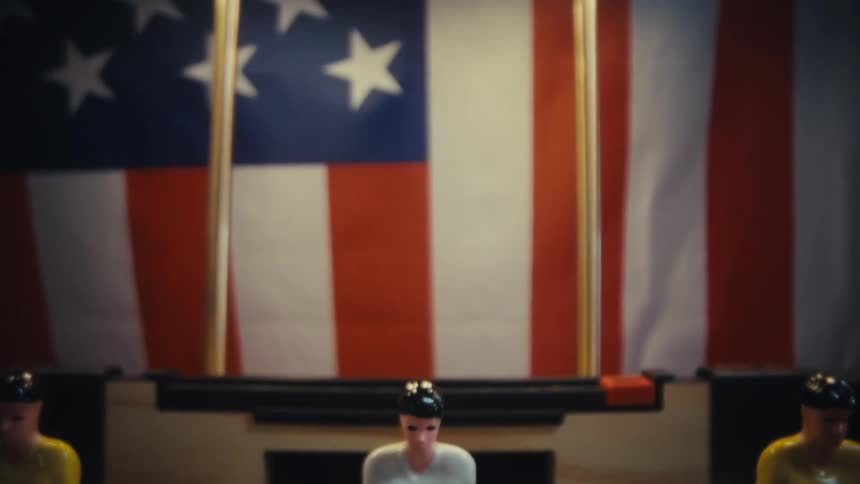 Foosball table positioned with a united states flag in the background