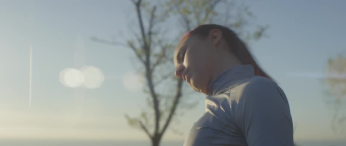 A woman is stretching her arms and neck then takes off