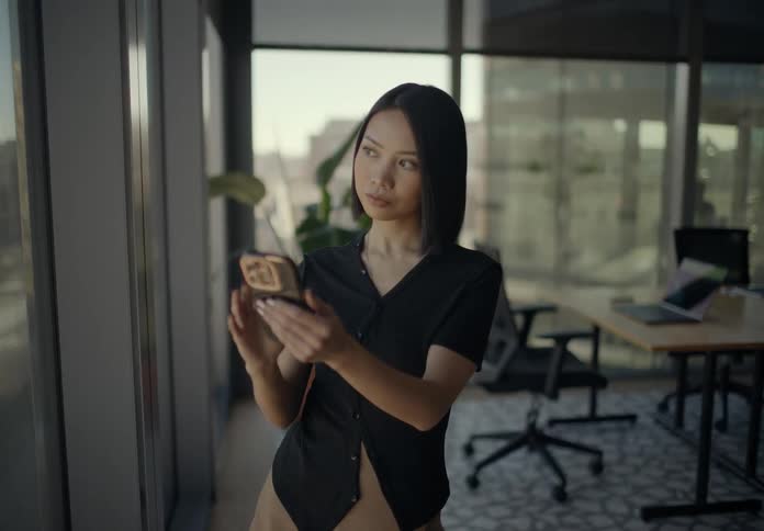 A woman using a smartphone in a room
