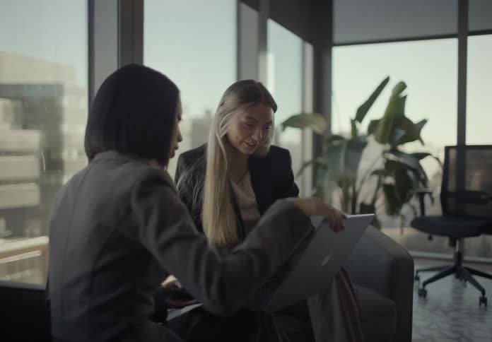 Two women looking at items on a laptop