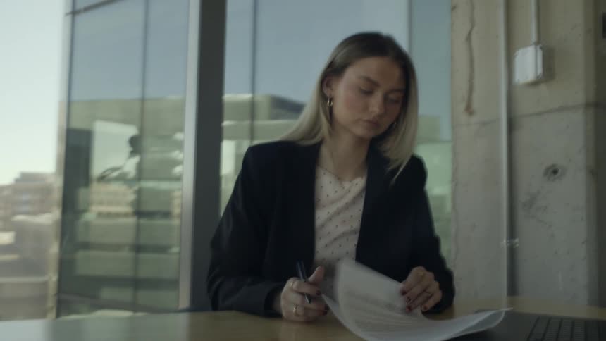 Woman reviewing a document on an office desk
