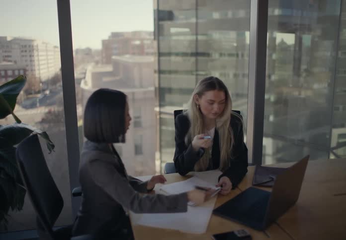 Two women talk in an office