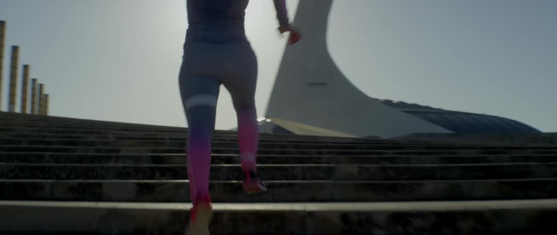 A woman runs up a flight of stairs