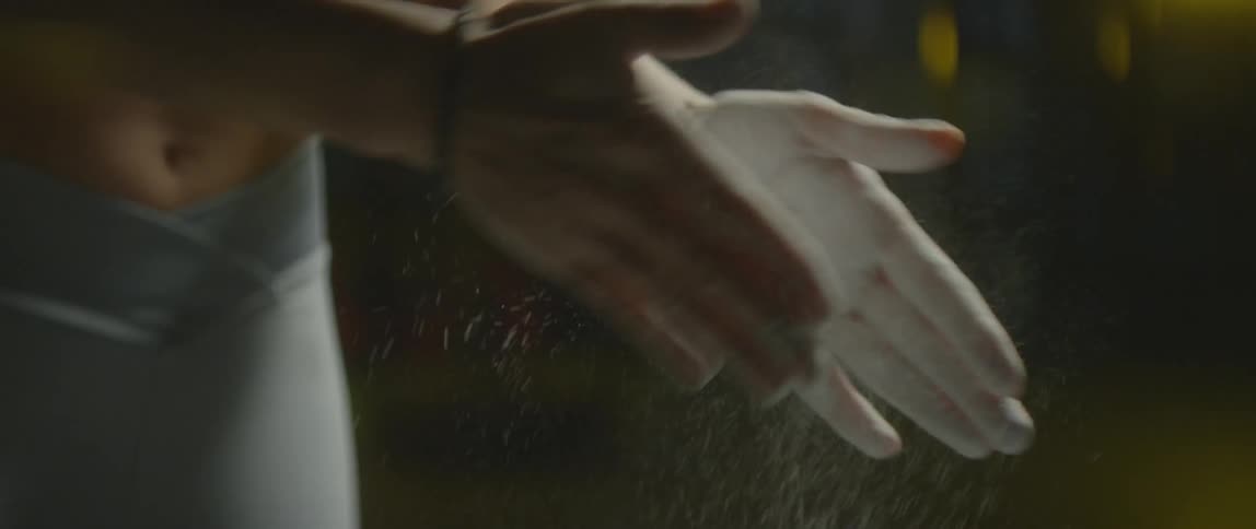 A woman rubs powder on her hands
