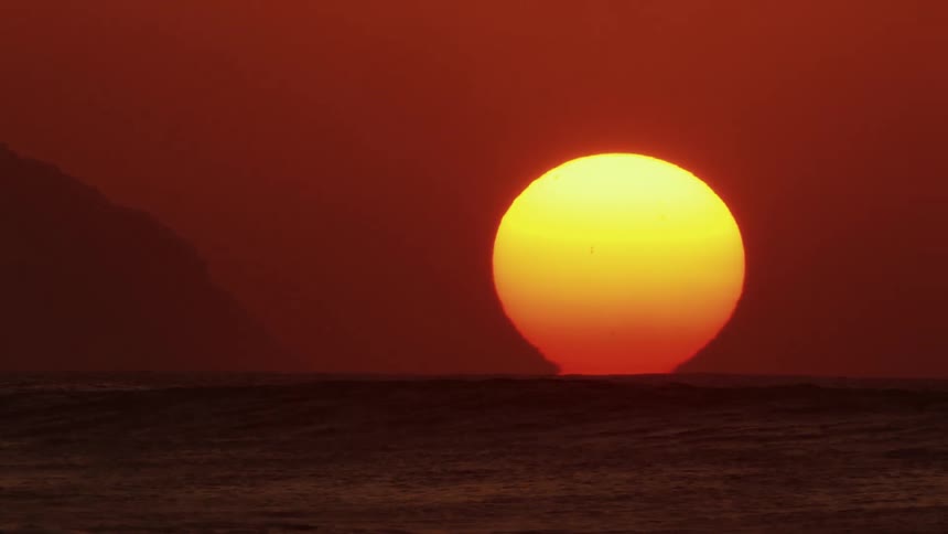 Seascape with the red moon on the horizon