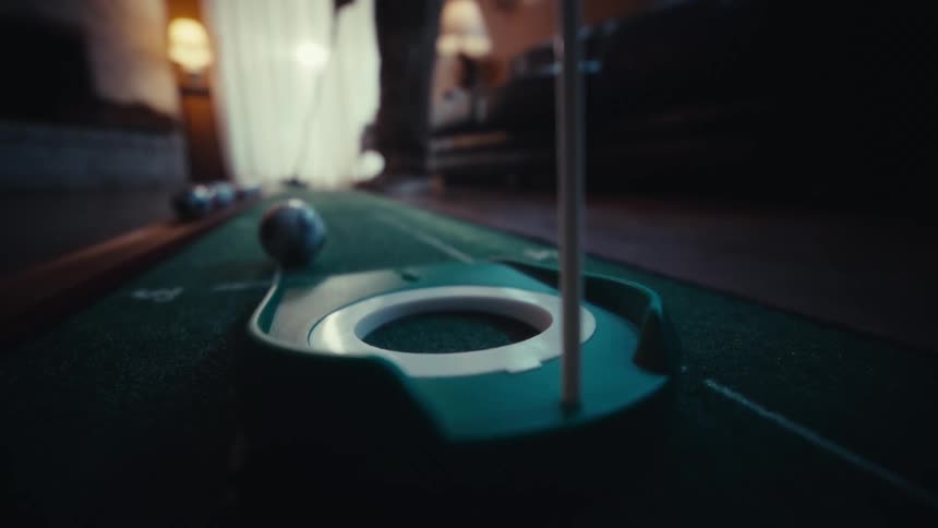 The person is using an indoor putter to play