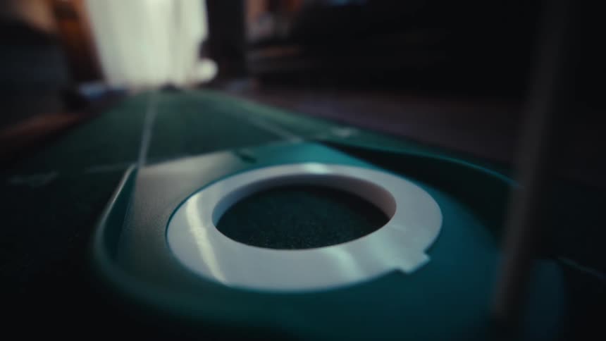 A golf ball rolls on a fake green