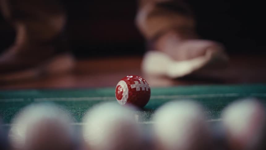 A person putting a golf ball in a room