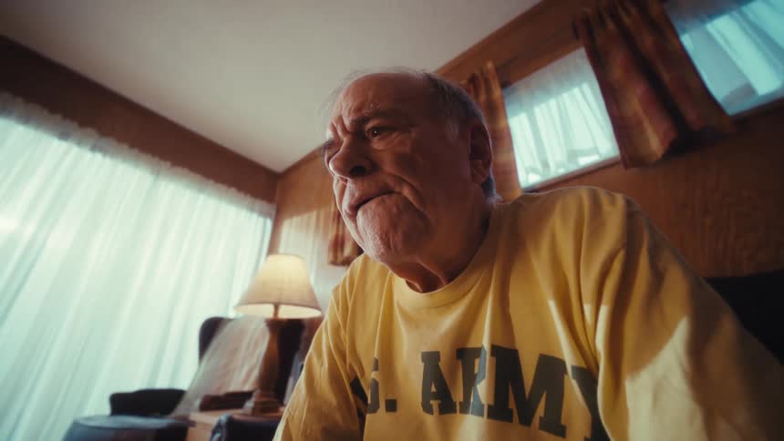 Elderly gentleman sitting in the living room