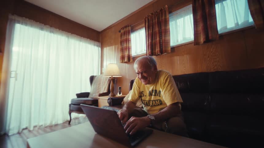 Elderly man opened a laptop and began to type