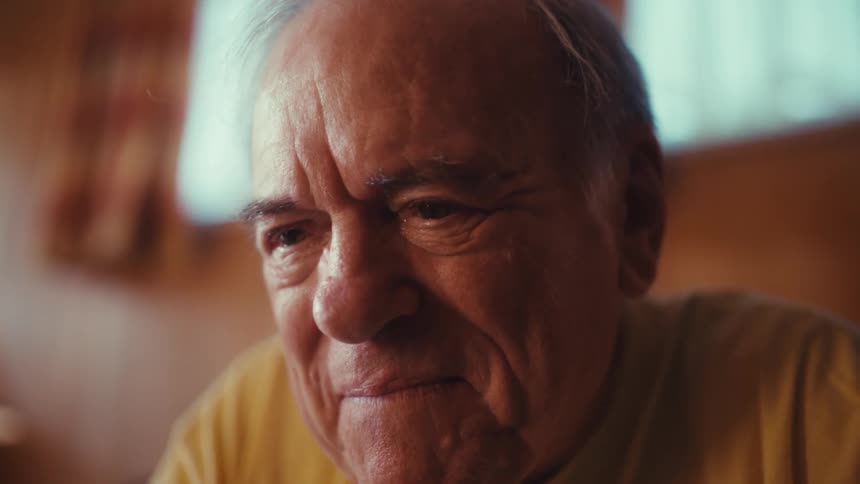 Portrait of an elderly man in an indoor space
