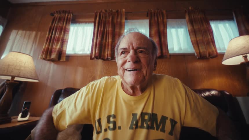 Elderly man with an emotional expression using a laptop