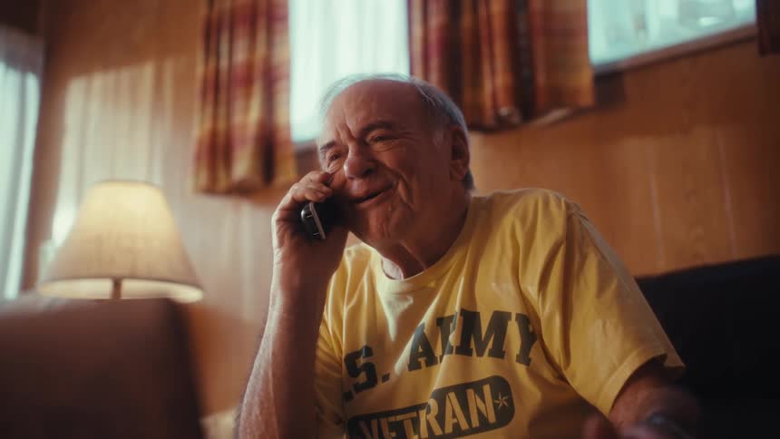 Elderly man on the phone sitting and talking