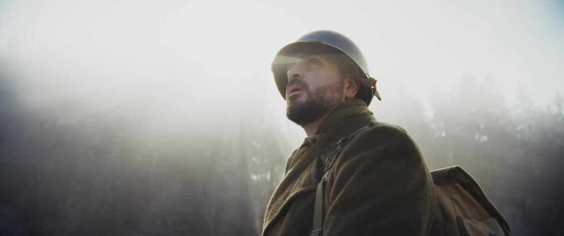 The soldier searches through the fog filled woods