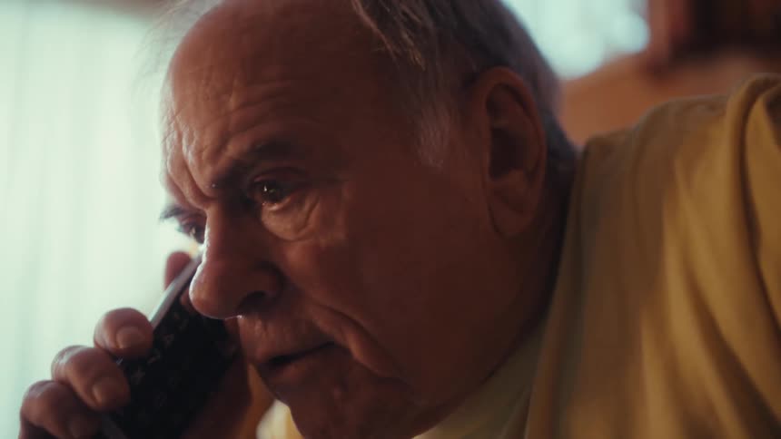 Elderly man sitting on a phone call