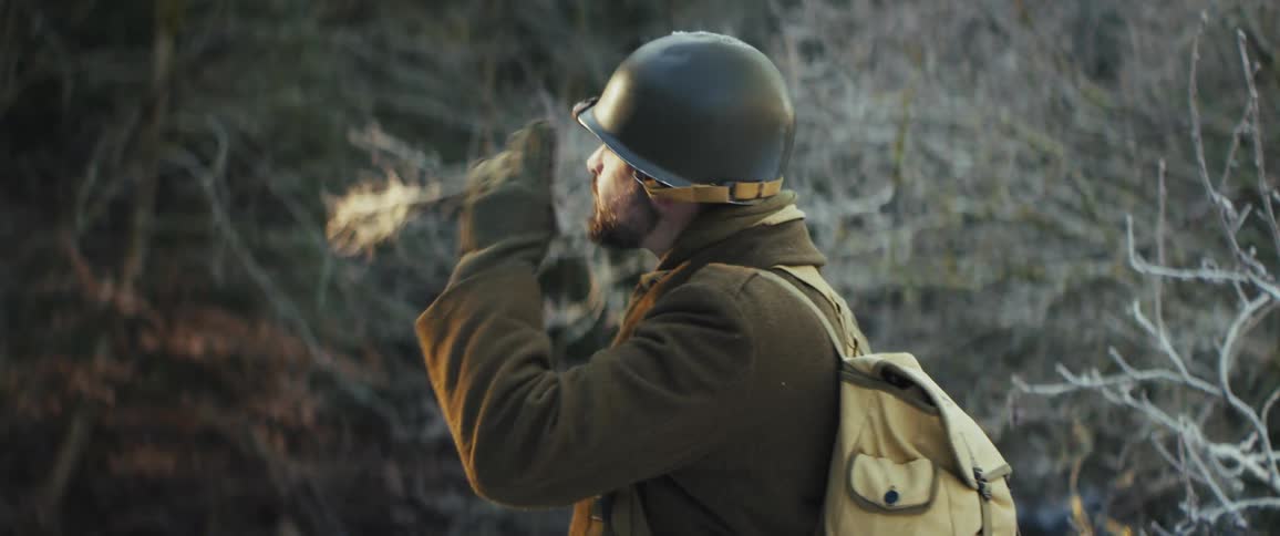 The soldier looks around while hiking in the forest