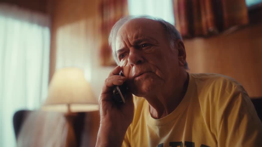 Elderly man sitting making a phone call