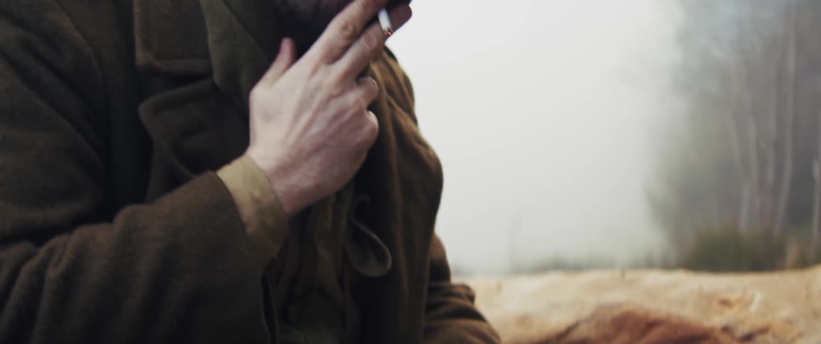 A soldier taking paper out of his pocket