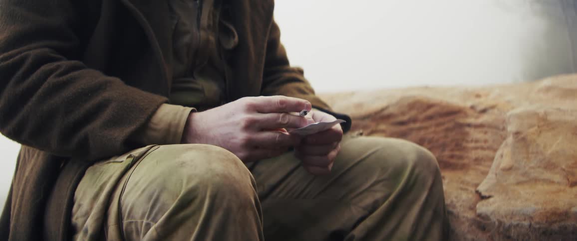 A soldier sitting outdoors smoking
