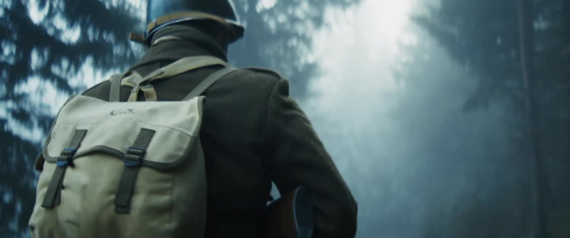 The soldier hikes through the foggy woods