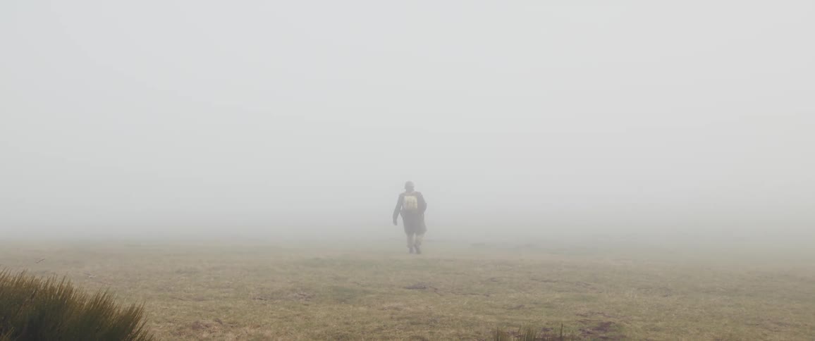 A soldier walking through a field