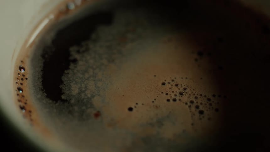 A cup of coffee sitting still on a surface