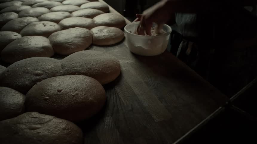 Wheat flour being poured into bread dough