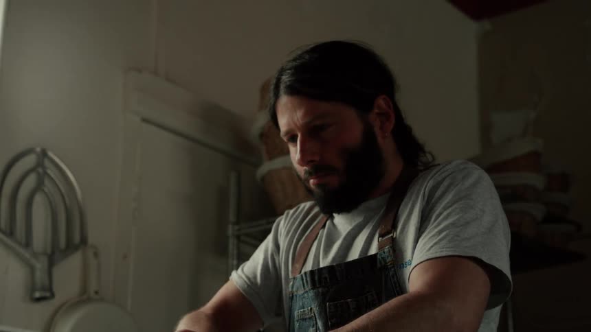 Man in apron cooking with bread dough