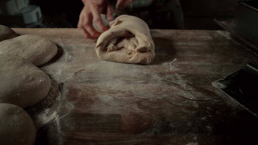 A person making a loaf of bread