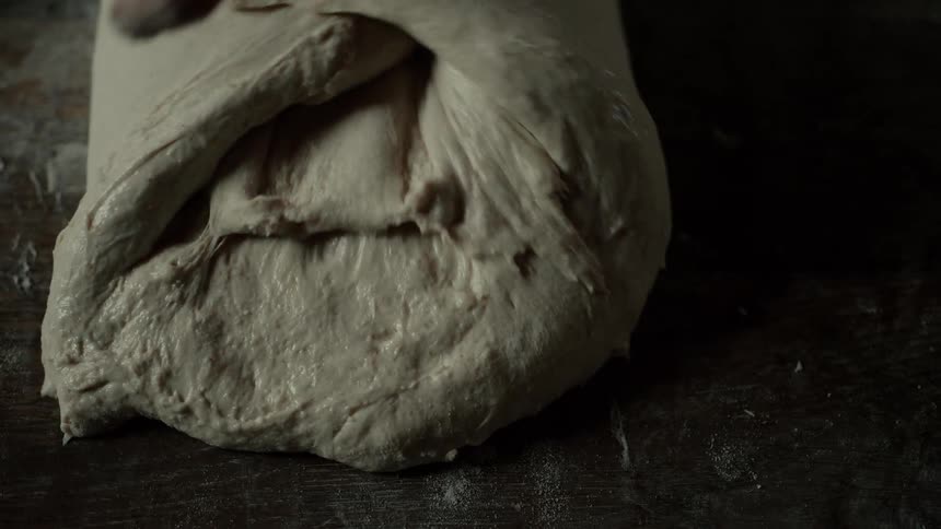 Pair of hands cooking bread dough