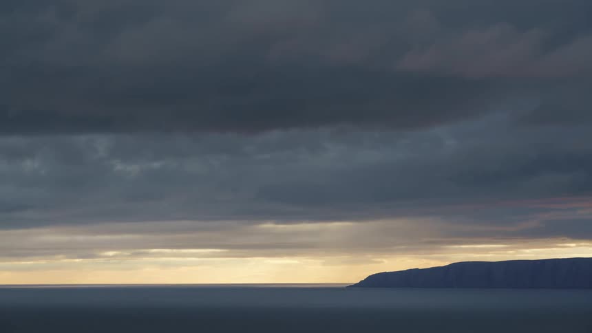 Ocean landscape with the silhouette of mountains on the horizon
