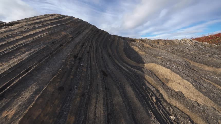 The mountain side is lined with crevices