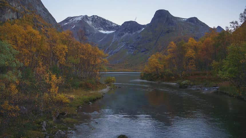 The river runs in a curve around the mountain