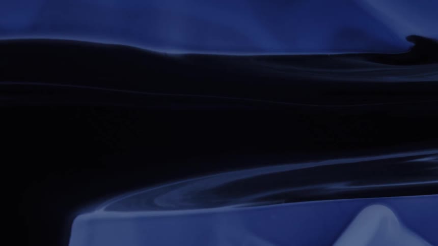 A sleek abstract band of dark glossy blue stretches horizontally across the frame with subtle ripples and liquidlike distortions reflecting light against a smooth deepblue background