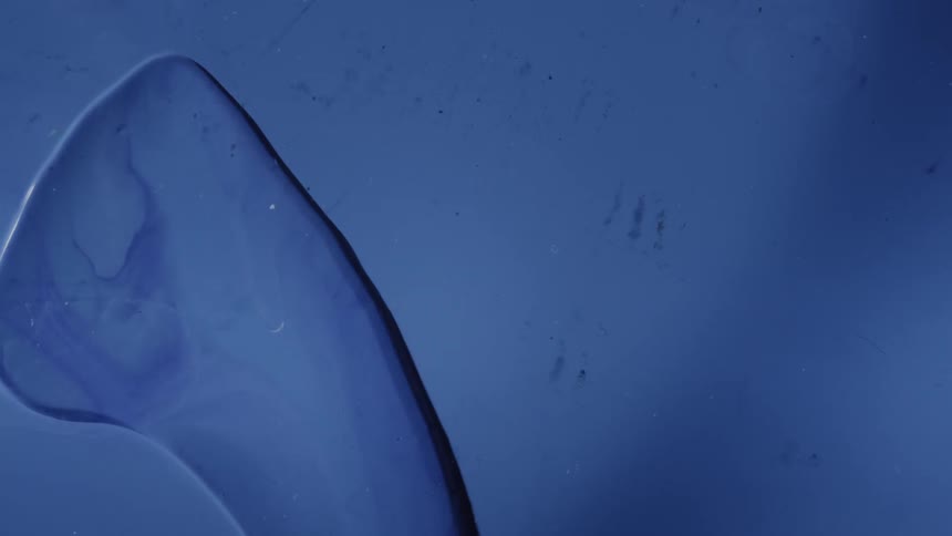 Pale color is streaked onto a surface afterwards a layer of translucent liquid is added then dries up