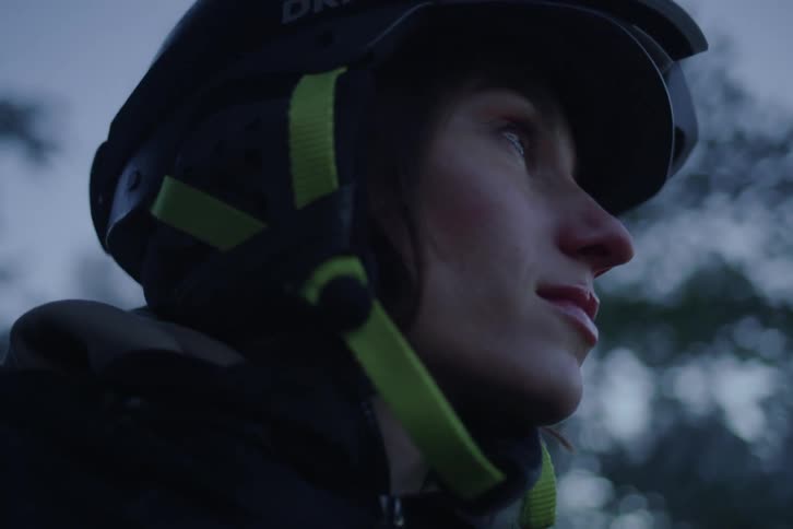 Young adult woman wearing a helmet with trees on the background outdoors