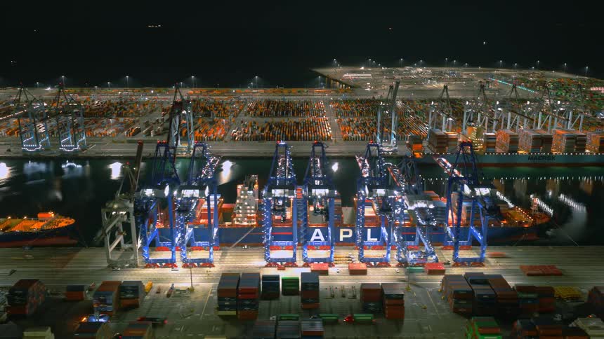 Aerial hyperlapse of container ships being loading with cargo at Port of Long Beach at night