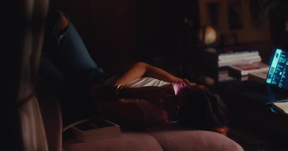 Woman lying down answering a call on a smartphone