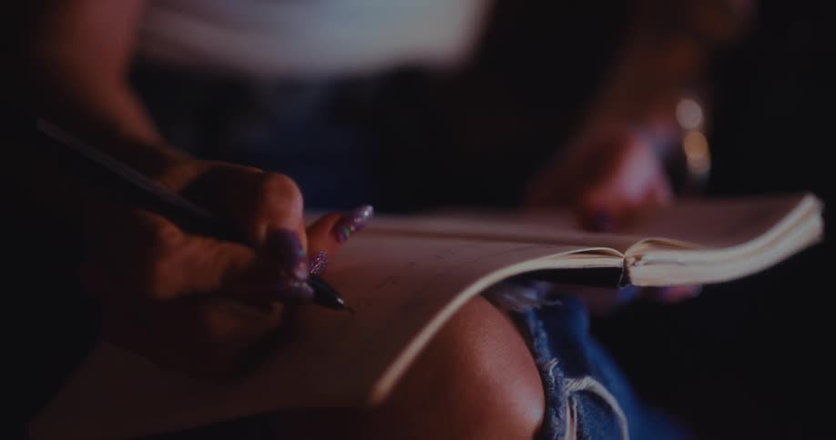 A person writing in a notebook