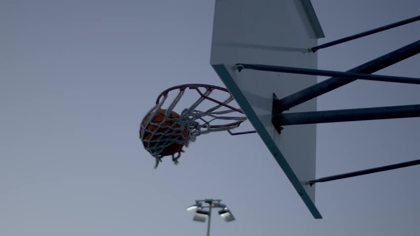 A basketball landing in a hoop