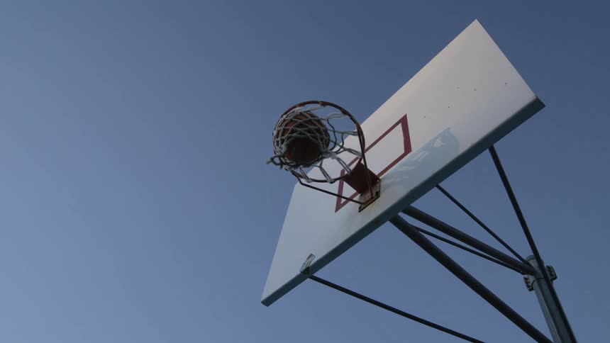 The basketball falls into the net for a score