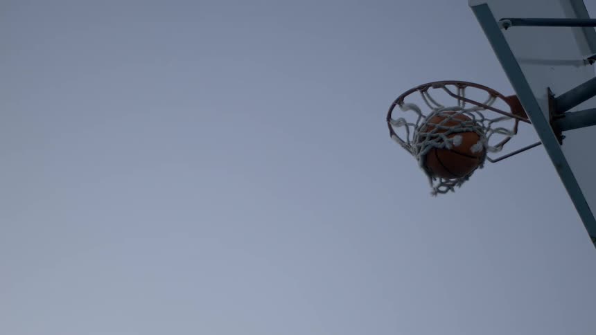 The basketball flies in the air and lands in the net