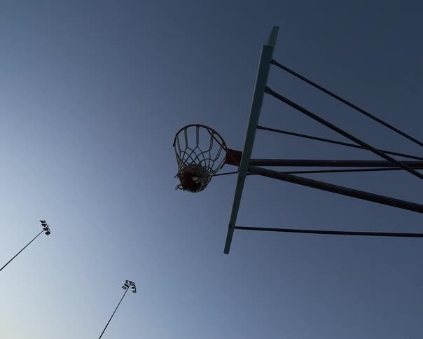 Longdistance ball falling into the basketball hoop