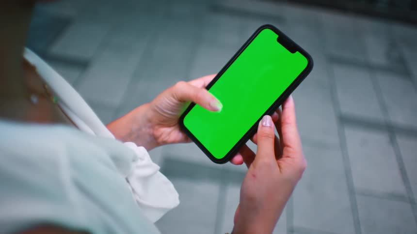 Close up of woman using smartphone with replaceable screen